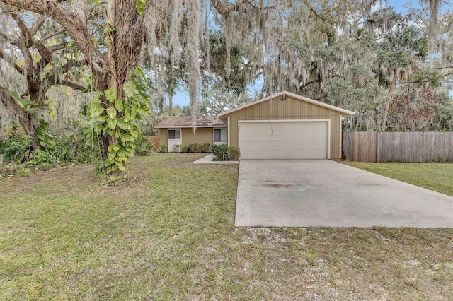 single story home featuring a garage and a front yard