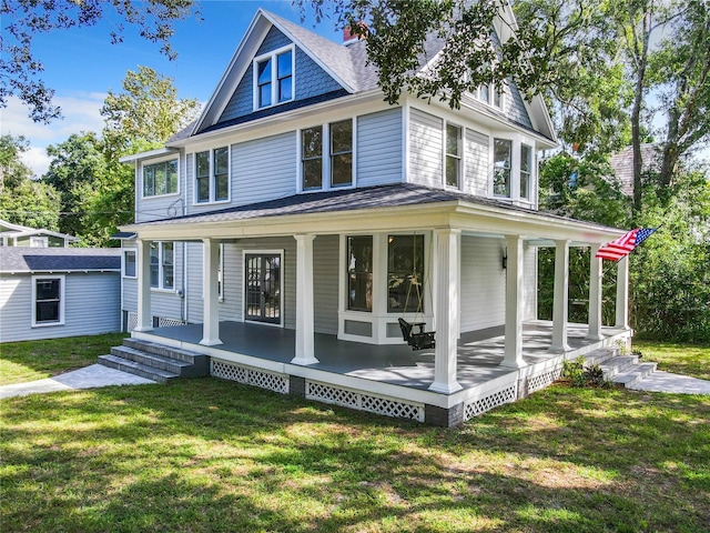 farmhouse-style home featuring a porch and a front lawn