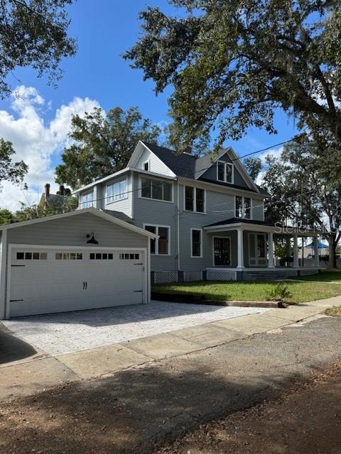 view of front of home featuring a porch and a garage