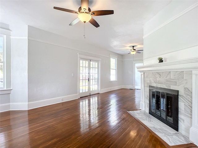 unfurnished living room featuring ceiling fan, dark hardwood / wood-style floors, and a fireplace