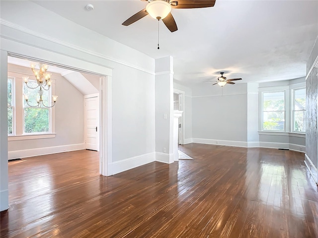 unfurnished room with ceiling fan with notable chandelier and dark hardwood / wood-style floors