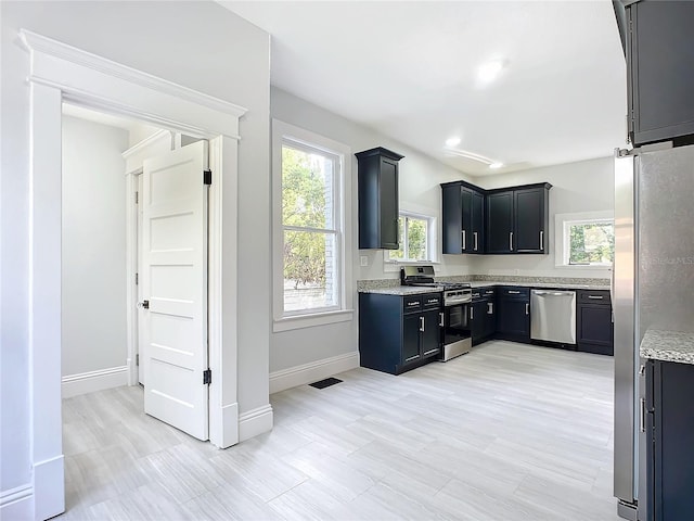 kitchen featuring light stone countertops and stainless steel appliances