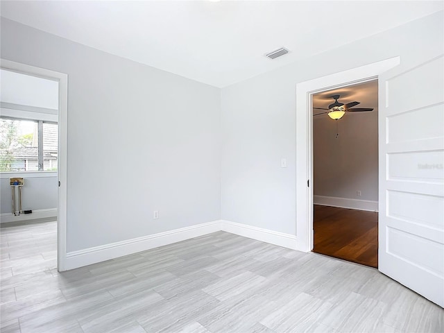 empty room featuring ceiling fan and light wood-type flooring