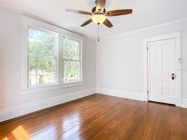 spare room featuring ceiling fan, dark hardwood / wood-style floors, and ornamental molding