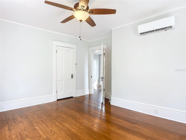 spare room featuring hardwood / wood-style flooring, a wall mounted AC, ornamental molding, and ceiling fan