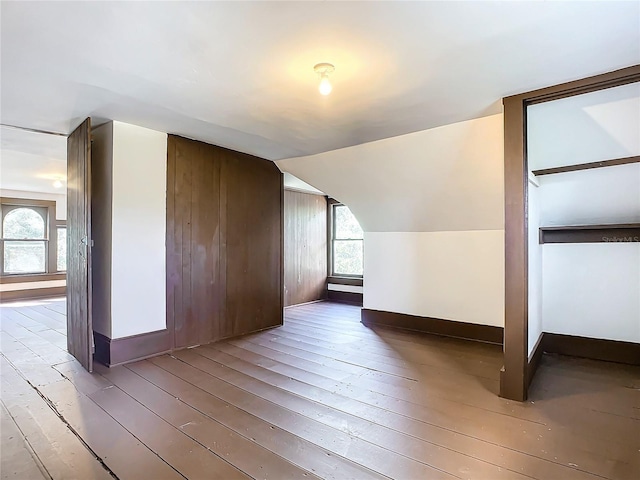 additional living space featuring hardwood / wood-style floors and vaulted ceiling