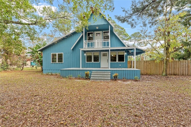 view of front of property with covered porch and a balcony