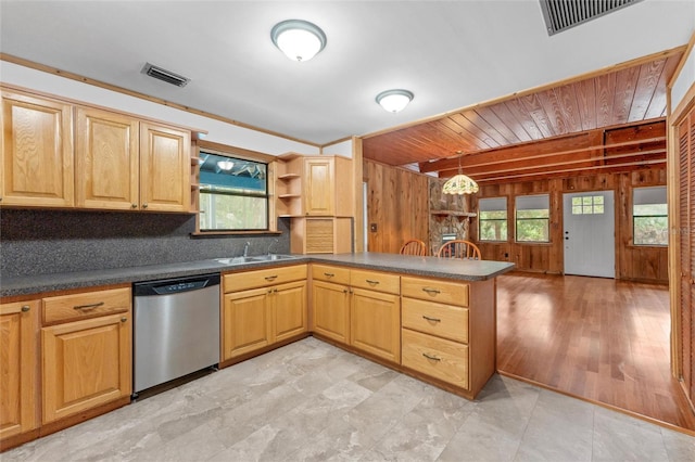 kitchen featuring dishwasher, wood walls, ornamental molding, decorative light fixtures, and kitchen peninsula