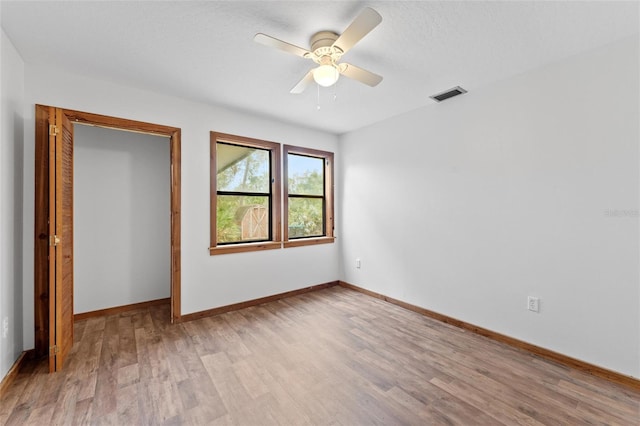 unfurnished bedroom featuring ceiling fan and light wood-type flooring