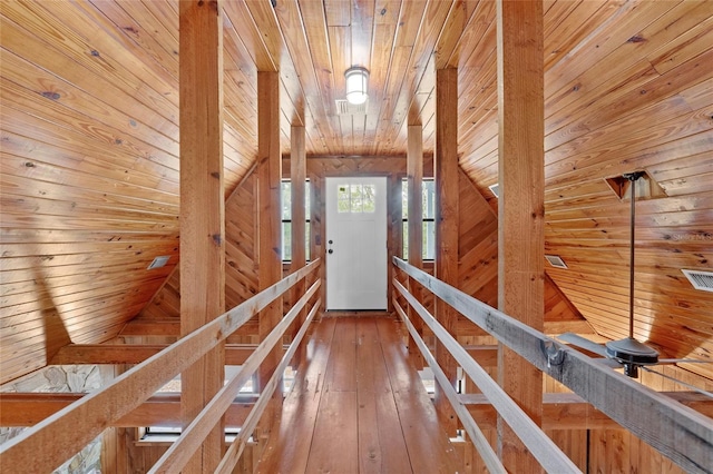 corridor with wooden walls, wooden ceiling, and wood-type flooring