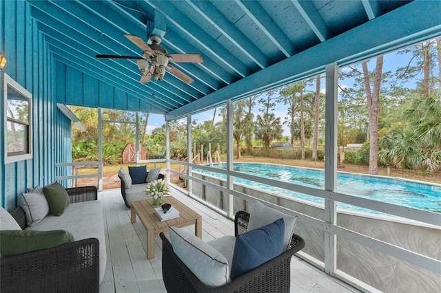 sunroom / solarium featuring lofted ceiling with beams, ceiling fan, and a healthy amount of sunlight