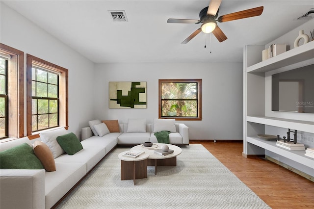 living room featuring ceiling fan and light hardwood / wood-style floors