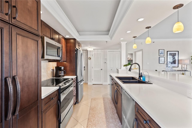 kitchen featuring sink, hanging light fixtures, crown molding, light tile patterned flooring, and appliances with stainless steel finishes