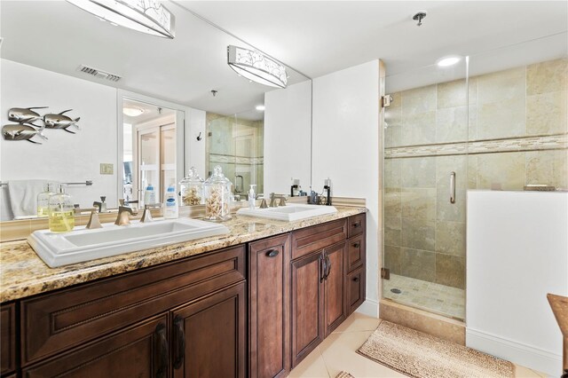 bathroom with tile patterned flooring, vanity, and an enclosed shower