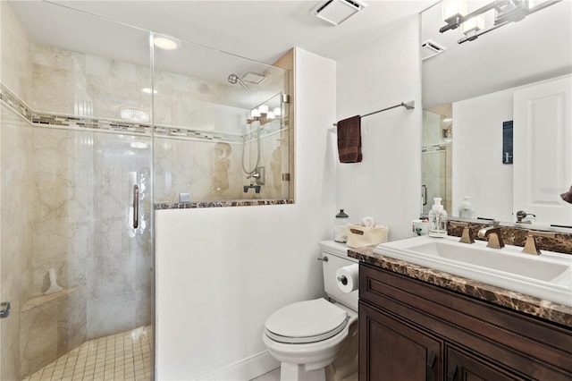 bathroom with vanity, toilet, and a shower with door