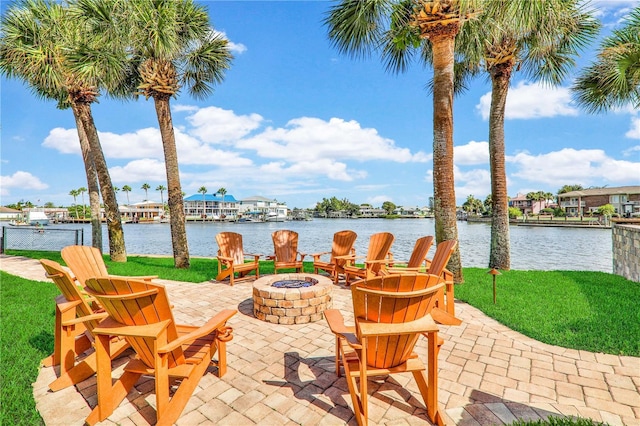 view of patio / terrace with a water view and a fire pit