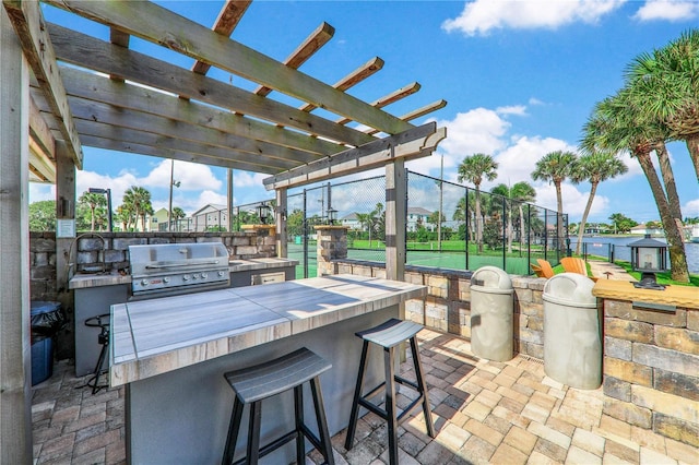 view of patio with a pergola, area for grilling, and exterior bar