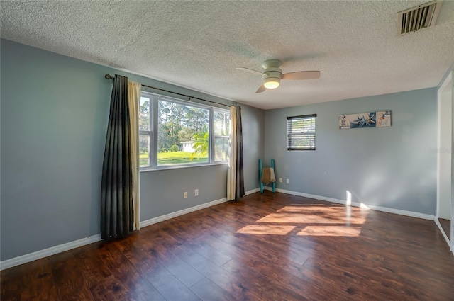 unfurnished room featuring a textured ceiling, ceiling fan, and dark wood-type flooring