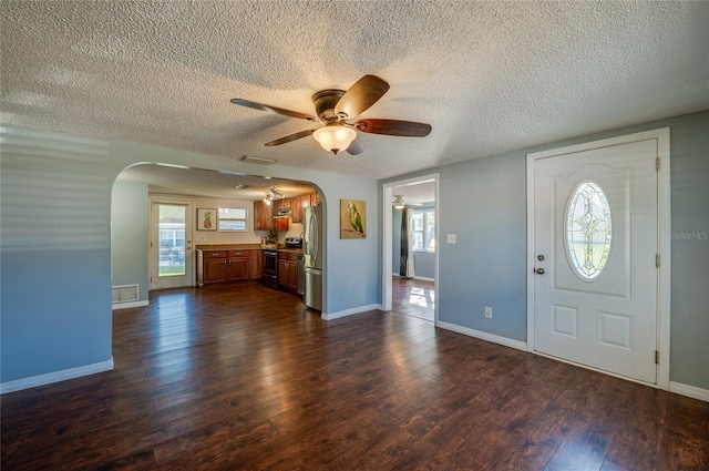 entryway featuring ceiling fan and dark wood-type flooring