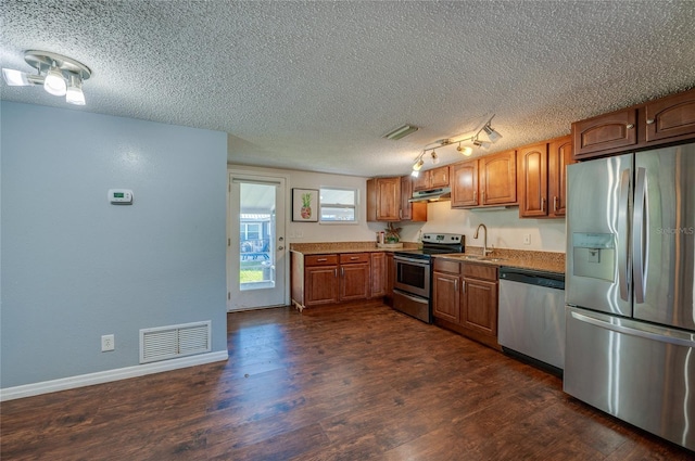 kitchen with dark hardwood / wood-style floors, sink, a textured ceiling, and appliances with stainless steel finishes