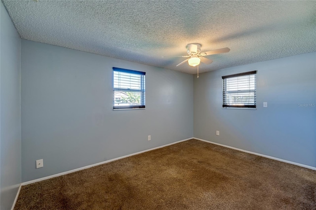 spare room featuring carpet, ceiling fan, and a textured ceiling