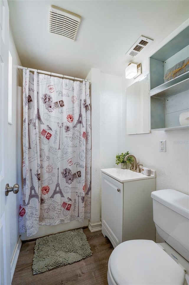 full bathroom with hardwood / wood-style flooring, vanity, toilet, and shower / tub combo with curtain