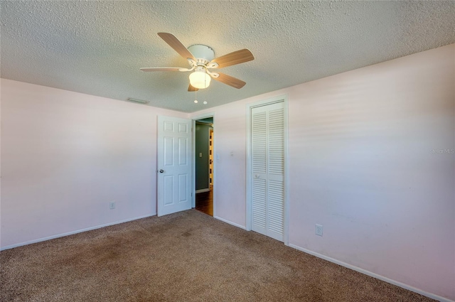 unfurnished bedroom with carpet, a textured ceiling, a closet, and ceiling fan