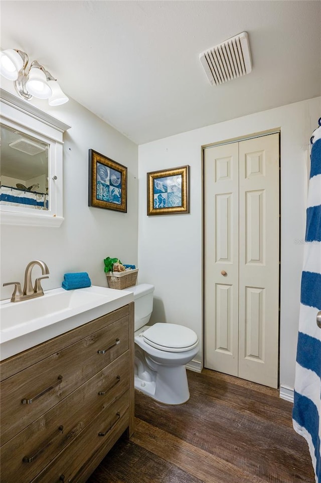 bathroom featuring hardwood / wood-style floors, vanity, and toilet