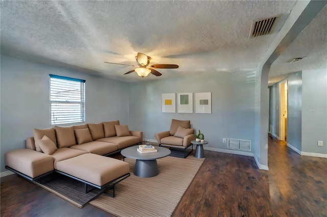 living room with ceiling fan and dark hardwood / wood-style floors