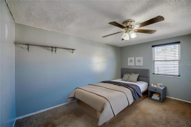 carpeted bedroom featuring a textured ceiling and ceiling fan