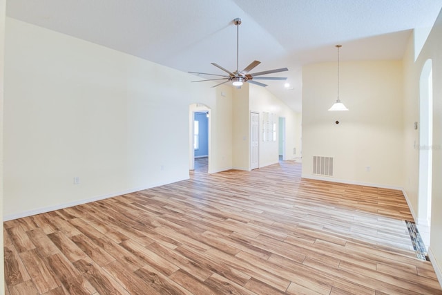 unfurnished living room with ceiling fan, high vaulted ceiling, and light wood-type flooring