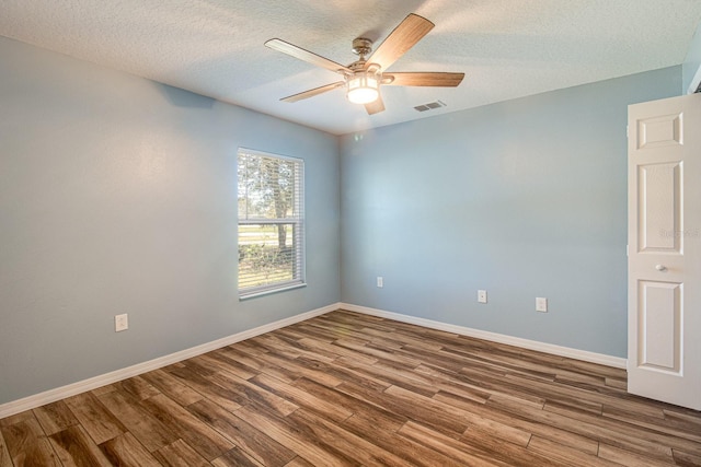 spare room featuring wood-type flooring, a textured ceiling, and ceiling fan