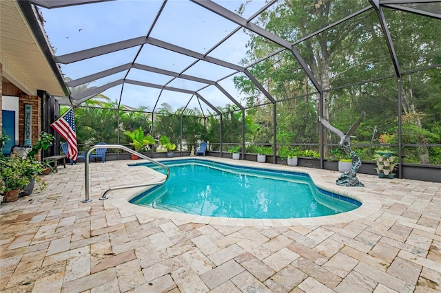 view of swimming pool featuring a lanai and a patio area