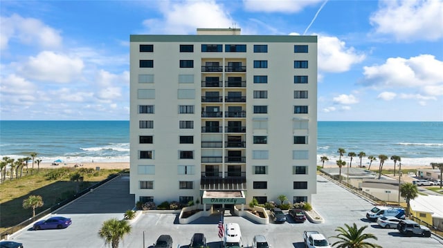 view of building exterior featuring a view of the beach and a water view