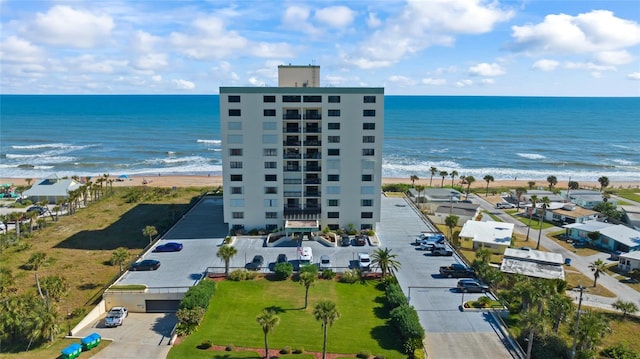 aerial view with a water view and a beach view