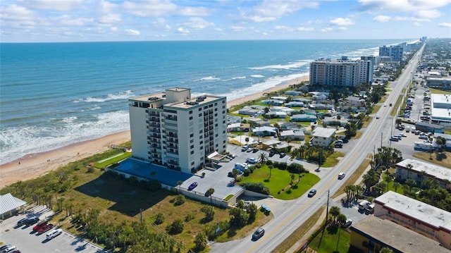 bird's eye view with a water view and a beach view