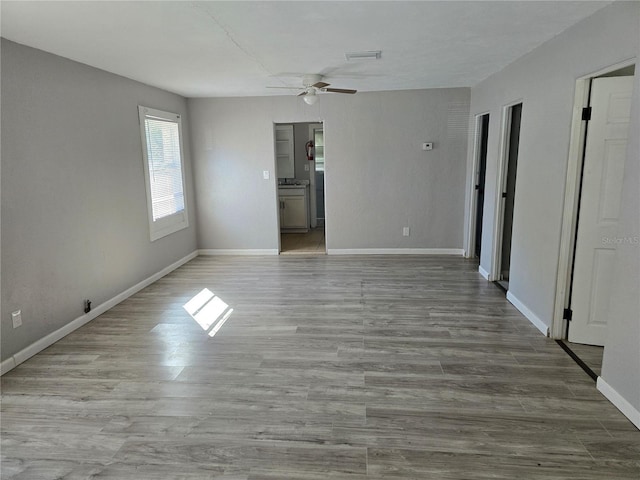 spare room featuring ceiling fan and light hardwood / wood-style flooring