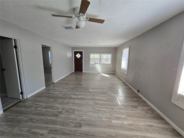 interior space with ceiling fan