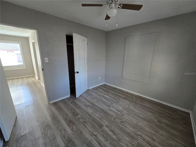 unfurnished bedroom with hardwood / wood-style flooring and ceiling fan