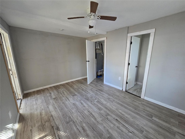 unfurnished bedroom with a closet, light hardwood / wood-style floors, and ceiling fan