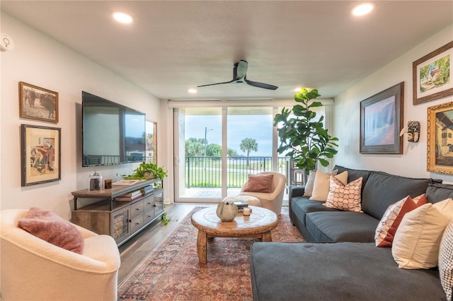 living room featuring hardwood / wood-style floors and ceiling fan