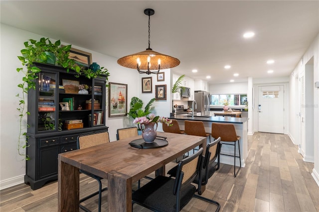 dining area featuring a chandelier and light hardwood / wood-style flooring