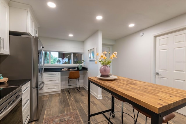 kitchen featuring white cabinets, dark hardwood / wood-style floors, and electric stove