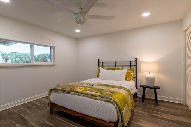 bedroom featuring dark hardwood / wood-style flooring, ceiling fan, and a closet