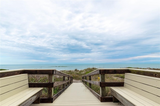 view of home's community featuring a water view and a beach view