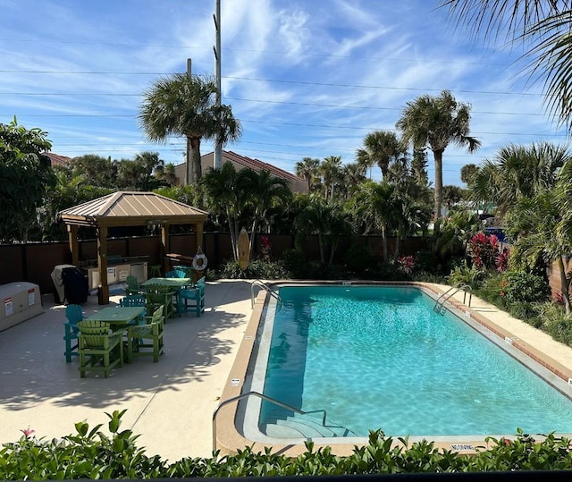 view of swimming pool featuring a gazebo and a patio