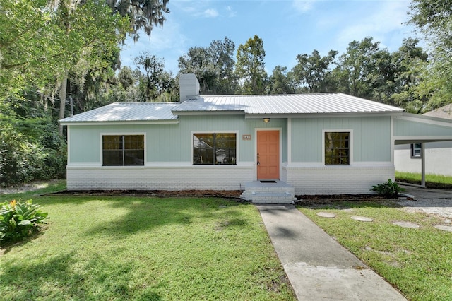 single story home with a front yard and a carport