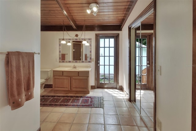 bathroom featuring beamed ceiling, vanity, toilet, and wooden ceiling