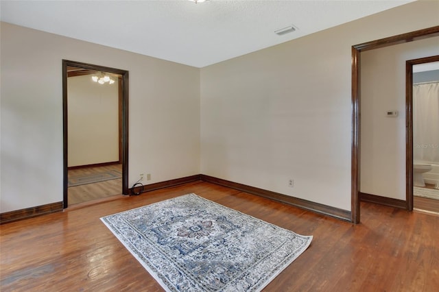 empty room with hardwood / wood-style flooring