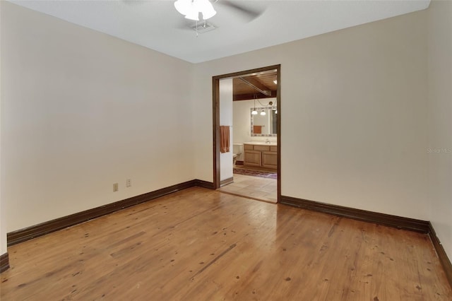 unfurnished room with beam ceiling, ceiling fan, light hardwood / wood-style flooring, and wood ceiling